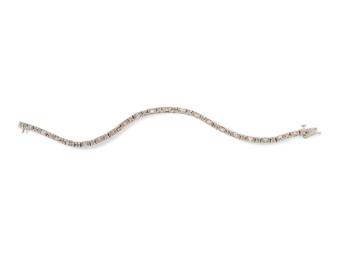 A 14 Karat White Gold and Diamond Bracelet,: A 14 Karat White Gold and Diamond Bracelet, containing 21 round brilliant cut diamonds weighing approximately 0.60 carat total and 40 baguette cut diamonds weighing approximately 1.10 carats total. St