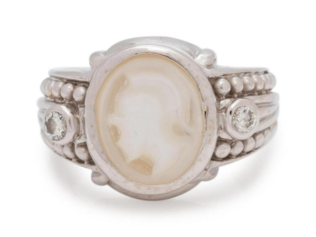 An 18 Karat White Gold, Carved Hardstone and Diamond: An 18 Karat White Gold, Carved Hardstone and Diamond Ring, Judith Ripka, containing one oval shape carved mother-of-pearl plaque depicting a Classical warrior profile and two round brilliant cut diamo