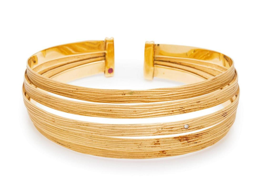 An 18 Karat Yellow Gold and Diamond: An 18 Karat Yellow Gold and Diamond 'Rayada' Cuff Bracelet, Roberto Coin, consisting of five brushed gold flat wires, containing one round brilliant cut diamond. Stamp: 18Kt ITALY (Italian hallmark).�