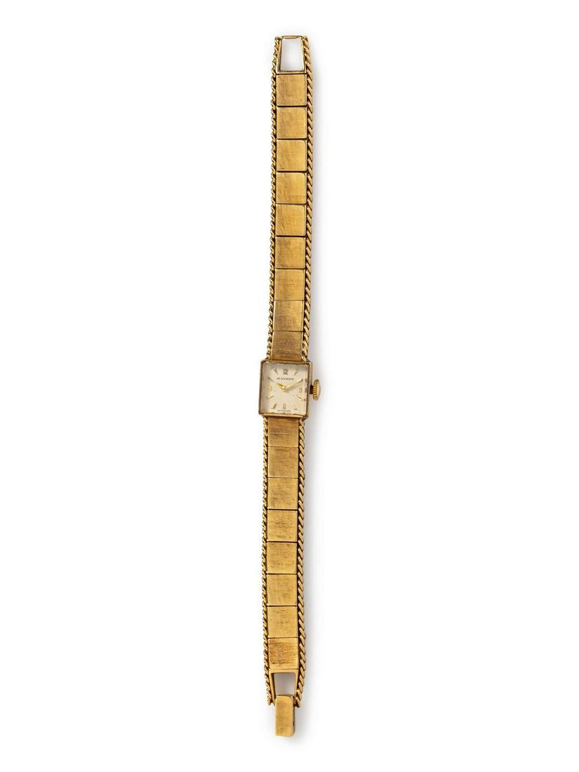 A 14 Karat Yellow Gold Wristwatch, Movado,: A 14 Karat Yellow Gold Wristwatch, Movado, 11.00 X 13.00 mm case dimensions, white dial signed MOVADO, applied gold Arabic and baton numerals, gold sword hands, snap on case back, manual wind 17 jewel