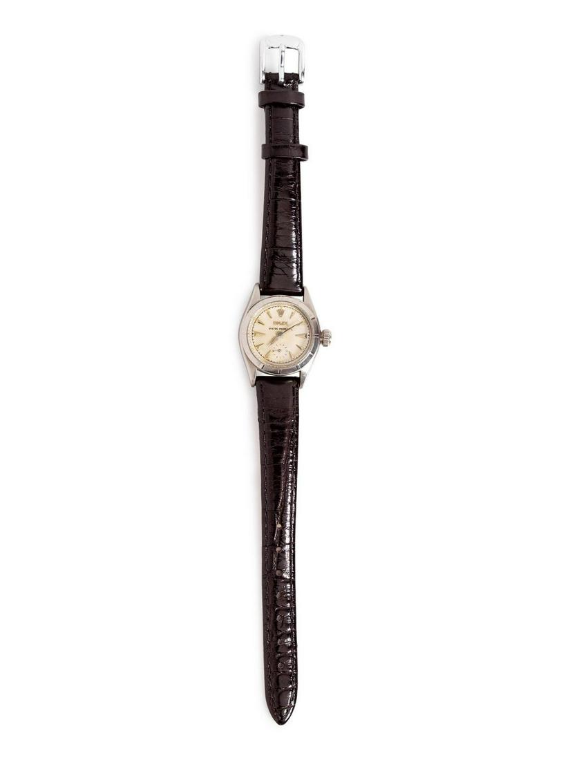 A Steel 'Oyster Perpetual' Wristwatch, Rolex,: A Steel 'Oyster Perpetual' Wristwatch, Rolex, 23.00 mm case diameter, textured cream dial signed ROLEX OYSTER PERPETUAL, subdial at 6 o'clock, automatic movement, black leather strap, steel tang buckl
