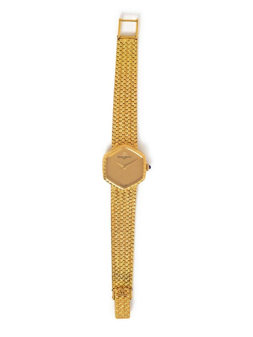 An 18 Karat Yellow Gold Wristwatch, Baume & Mercier,: An 18 Karat Yellow Gold Wristwatch, Baume & Mercier, 23.00 x 25.00 mm case dimensions, brushed textured champagne dial signed BAUME & MERCIER, gold pitched dauphine hands, snap on case back, Cal. BM77