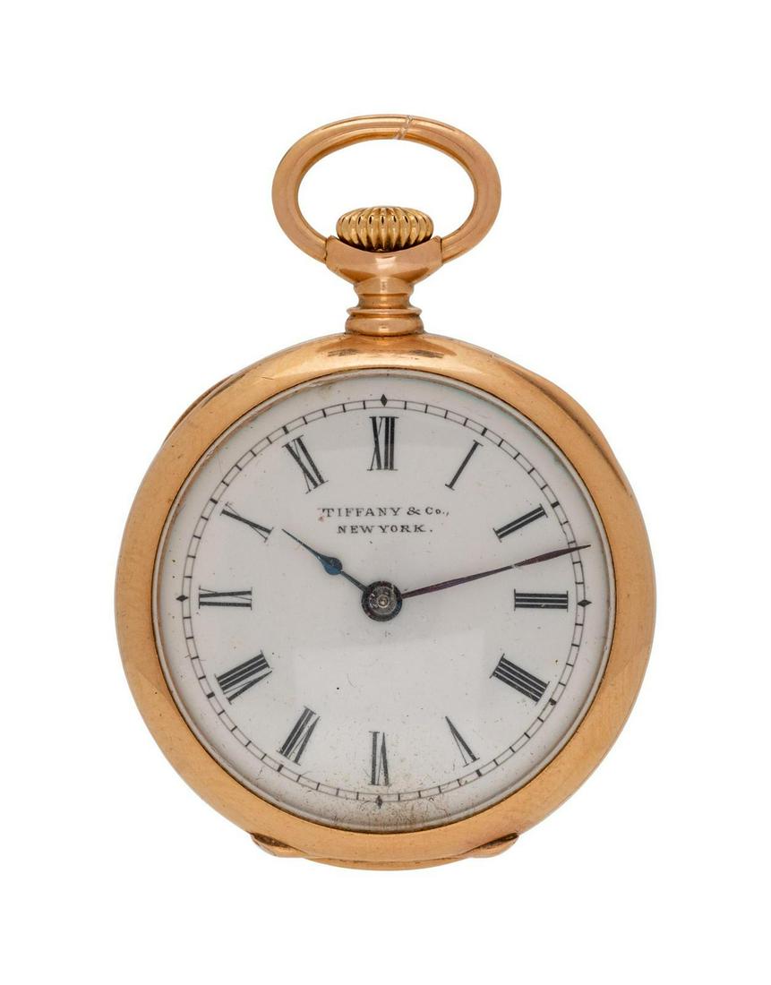 An 18 Karat Yellow Gold Open Face Pendant Watch,: An 18 Karat Yellow Gold Open Face Pendant Watch, Tiffany & Co., 26.00 mm case diameter, white dial signed TIFFANY & CO. NEW YORK, Roman numerals, blued steel spade hands, polished case with engraved m