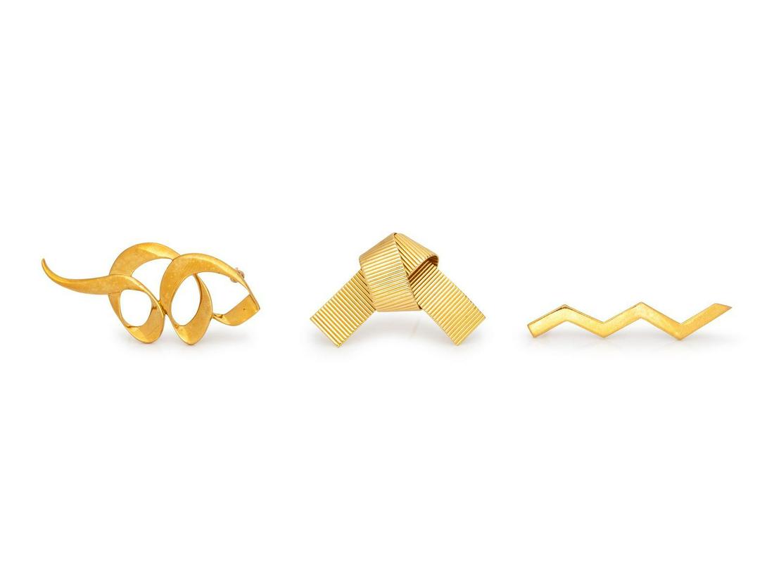 A Collection of Yellow Gold Brooches, Tiffany & Co.,: A Collection of Yellow Gold Brooches, Tiffany & Co., consisting of an 18 karat zig zag brooch by Paloma Picasso, a 14 karat ribbed knot motif brooch, together with an 18 karat swirling brooch by Palom