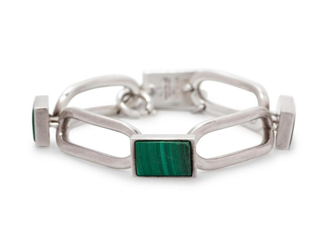 A Sterling Silver and Malachite Bracelet, Henning: A Sterling Silver and Malachite Bracelet, Henning Ulrichsen, containing four rectangular malachite plaques alternating with oval shape silver links. Stamp: (maker's mark) 925 S STERLING HANDMADE IN DE