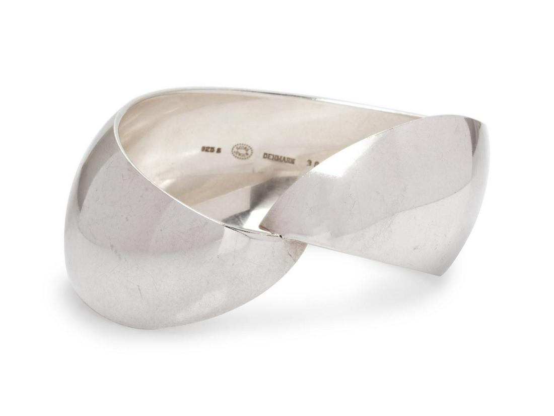A Modernist Sterling Silver Bangle Bracelet, Nanna: A Modernist Sterling Silver Bangle Bracelet, Nanna Ditzel Georg Jensen, in a curved organic form. Stamp: 925 S (maker's mark) DENMARK 382. 62.60 dwts. Provenance:
