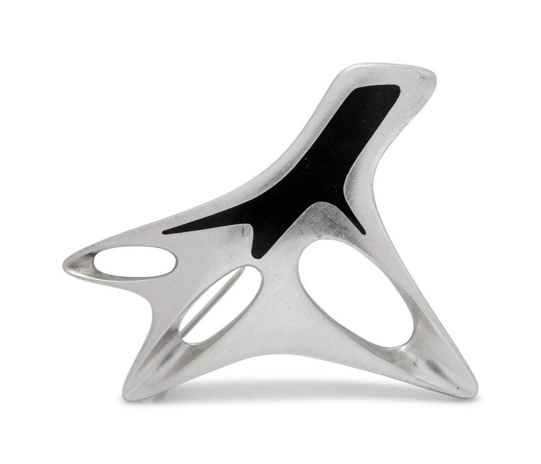 A Modernist Sterling Silver and Enamel Brooch, Henning: A Modernist Sterling Silver and Enamel Brooch, Henning Koppel for Georg Jensen, in a biomorphic form, with black enamel detail. Stamp: (maker's mark) STERLING DENMARK 323 (maker's mark for Henning Kop