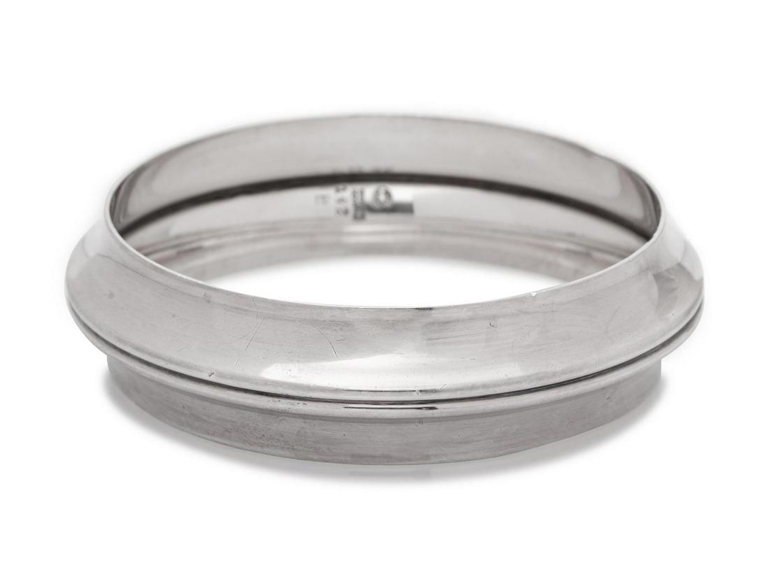 A Modernist Sterling Silver Bangle Bracelet, Nanna: A Modernist Sterling Silver Bangle Bracelet, Nanna Ditzel for Georg Jensen, designed as two joining concave bangles. Stamp: (maker's mark) STERLING DENMARK 142 B. 42.80 dwts. Provenance: