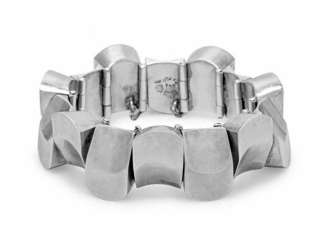 A Silver Bracelet, Antonio Pineda,: A Silver Bracelet, Antonio Pineda, consisting of curved hinged links, with safety chain. Stamp: (maker's mark) TAXCO 970. 79.20 dwts. Provenance: