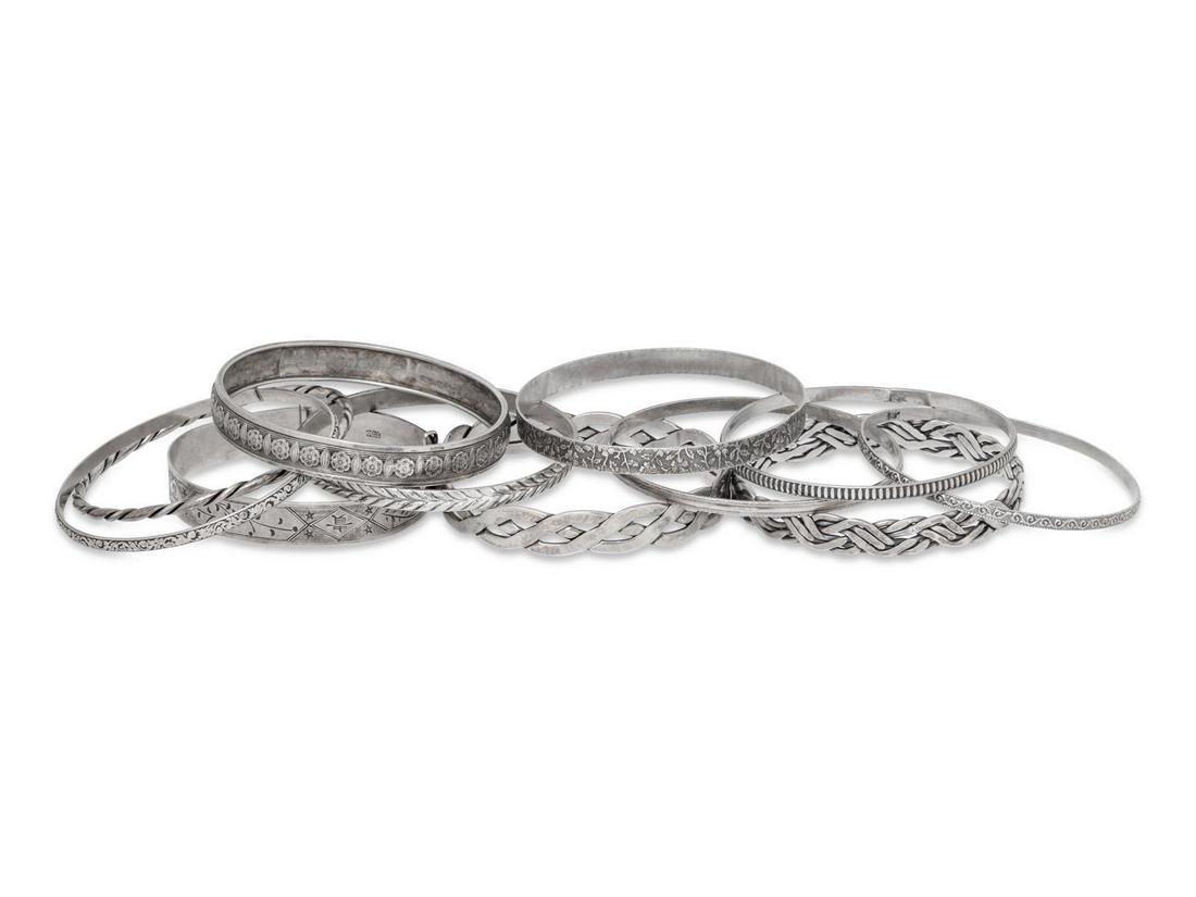 A Collection of Sterling Silver Bangles,: A Collection of Sterling Silver Bangles, consisting of 10 bangles with various decorative patterns. Stamp: STERLING. Stamp: STERLING RAJ. Stamp: BEAU STERLING. 85.20 dwts. Provenance: