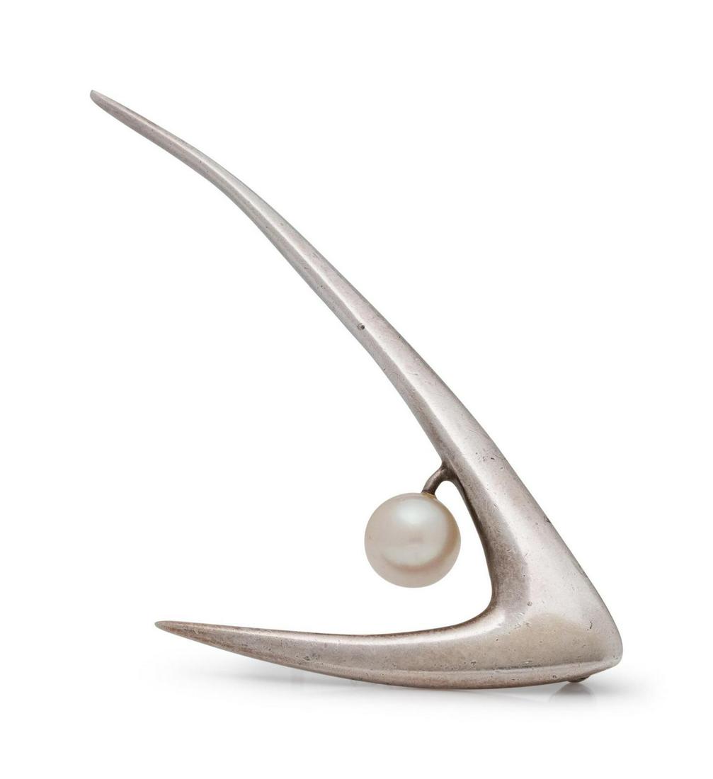 A Silver and Cultured Pearl Brooch, Ed Wiener,: A Silver and Cultured Pearl Brooch, Ed Wiener, unsigned, consisting of a sculptural design containing one pearl measuring approximately 7.50 mm in diameter. 6.95 dwts. Provenance: Property of a Univer