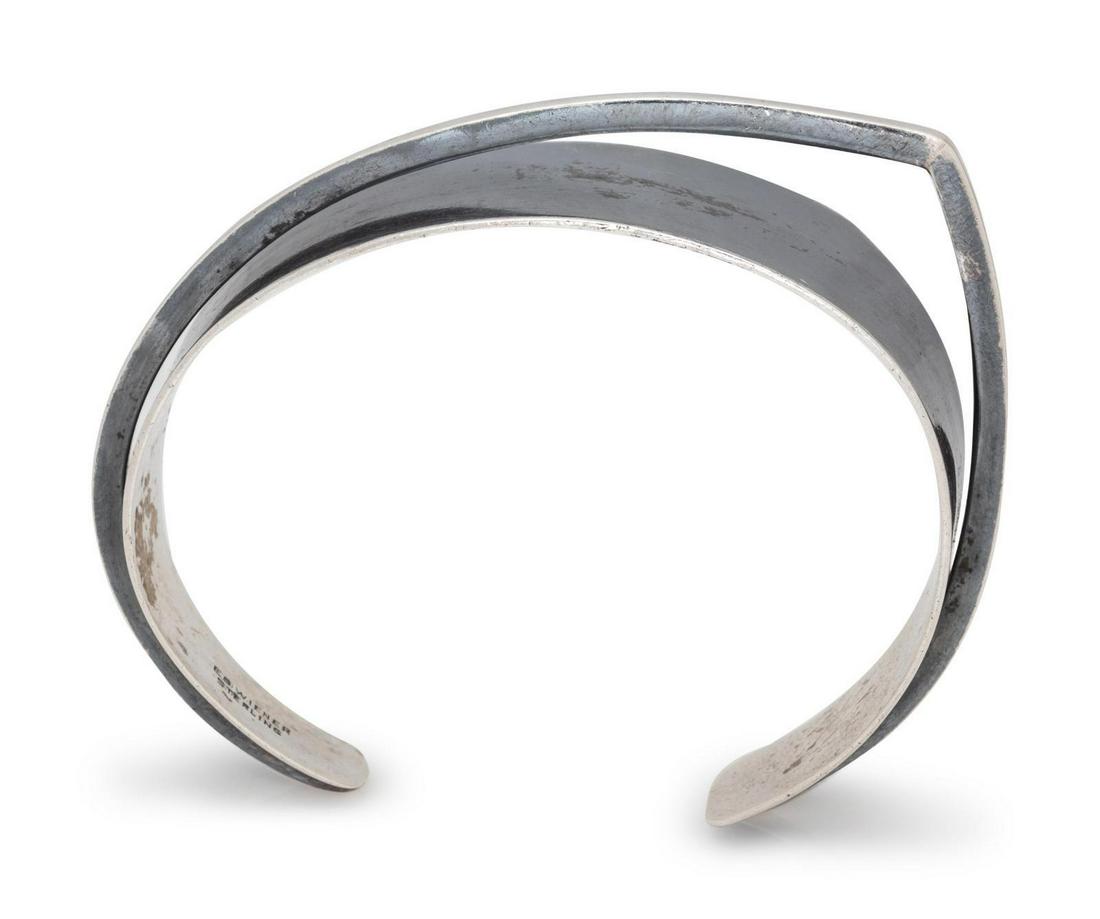 A Sterling Silver Cuff Bracelet, Ed Wiener,: A Sterling Silver Cuff Bracelet, Ed Wiener, consisting of a geometric design cuff surmounted with square wire. Stamp: ED WIENER STERLING. 16.45 dwts. Provenance: Property of a University of Chicago Em