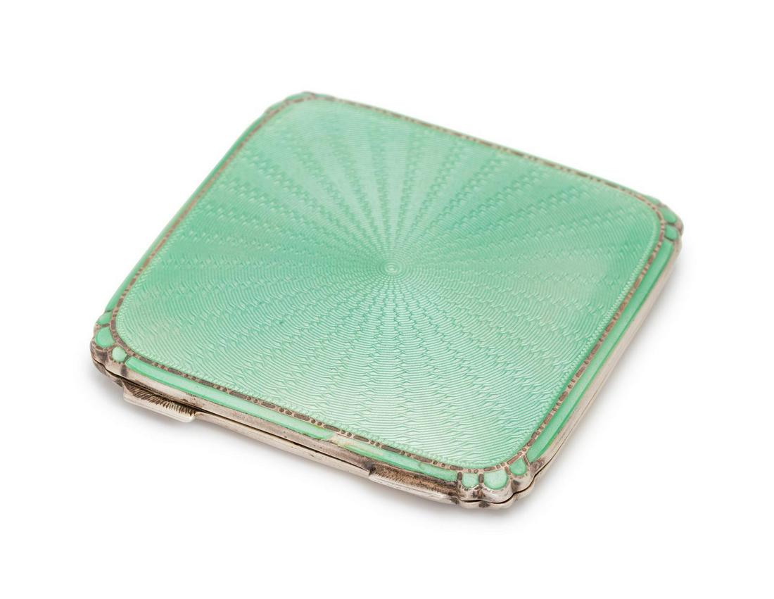 A Sterling Silver and Enamel Compact, British,: A Sterling Silver and Enamel Compact, British, consisting of a hinged case with green guilloche enamel, with interior mirror. Stamp: (British hallmarks) MADE IN ENGLAND. 53.25 dwts. Provenance: Proper