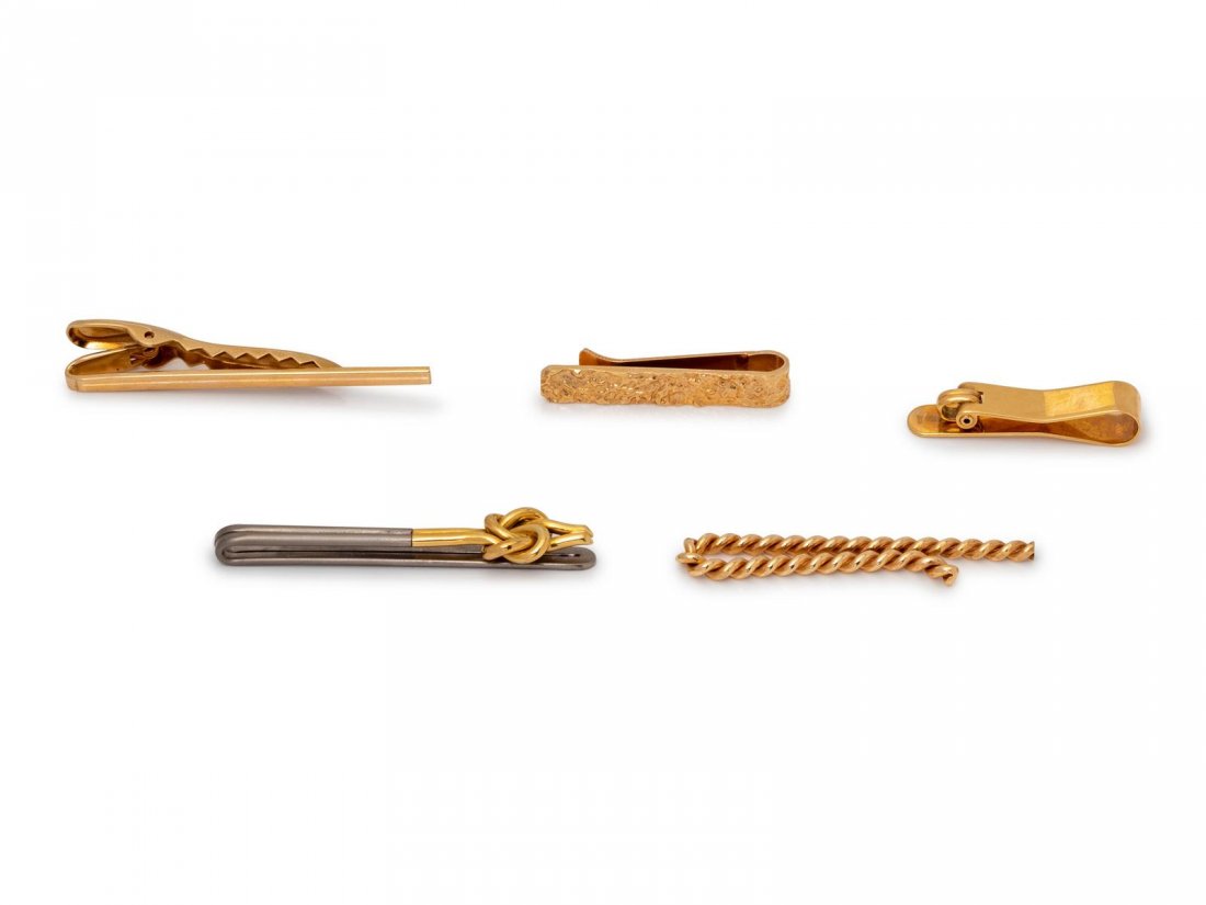 A Collection Yellow Gold and Titanium Tie Bars,: A Collection Yellow Gold and Titanium Tie Bars, consisting of a 14 karat gold nugget motif tie bar, a 14 karat clip tie bar, an 18 karat gold clip tie bar, a twisted gold tie bar together with a knot