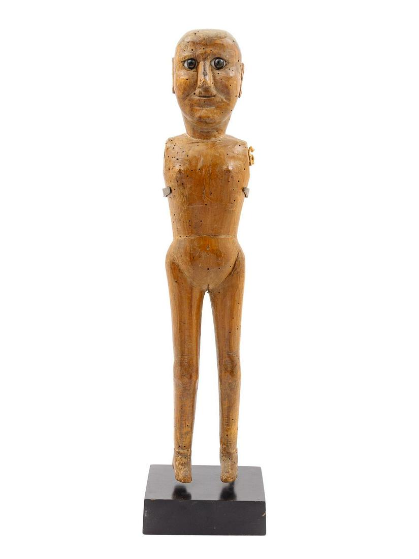 A Carved Wood Figure: A Carved Wood Figure raised on a stand. Height of figure 17 5/8 inches. Property from the Collection of Jonathan Hoffman, Chicago, Illinois