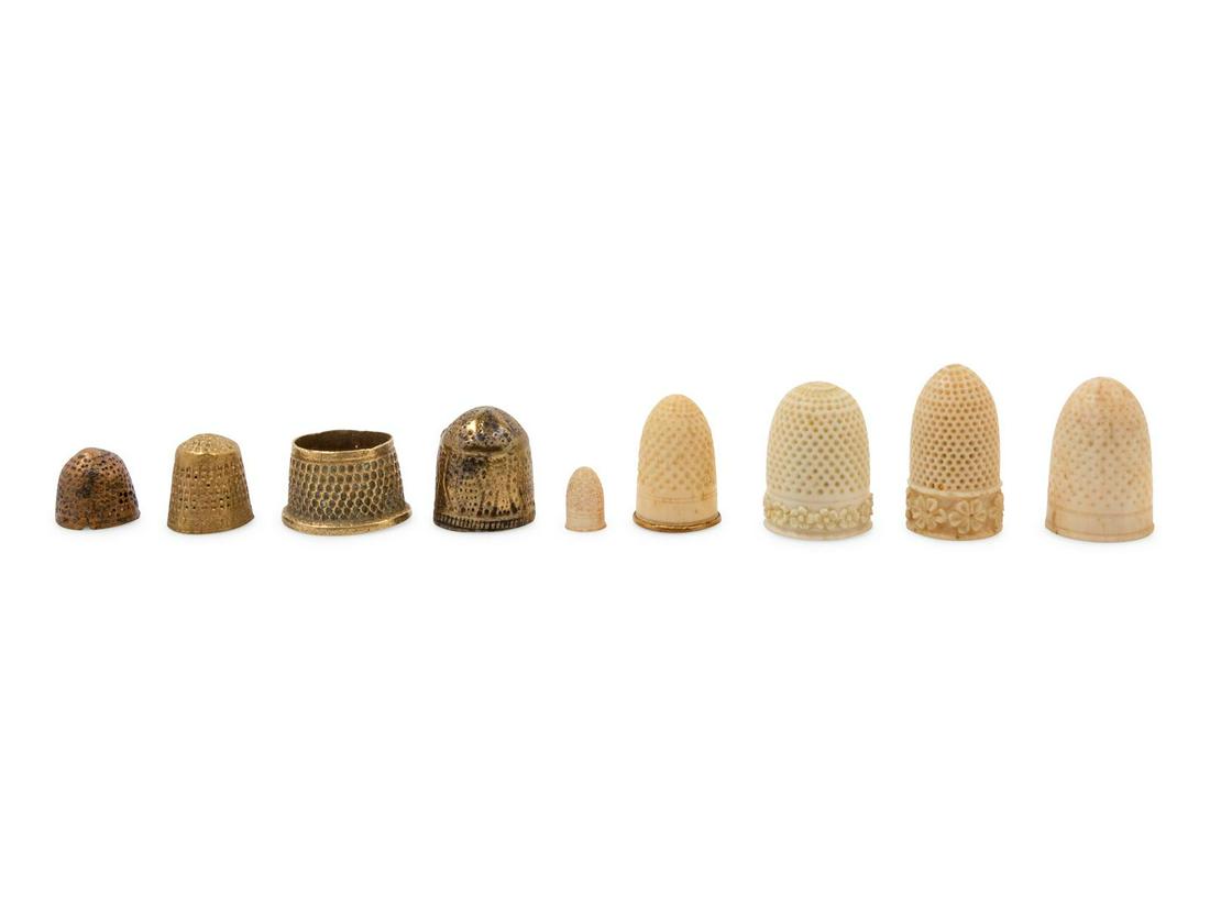 Nine Continental Carved and Mixed Metal Thimbles: Nine Continental Carved and Mixed Metal Thimbles 18th Century and Later comprising a metal open-top sail maker thimble, a carved doll's thimble and others. Height of tallest 1 inch. Property from the
