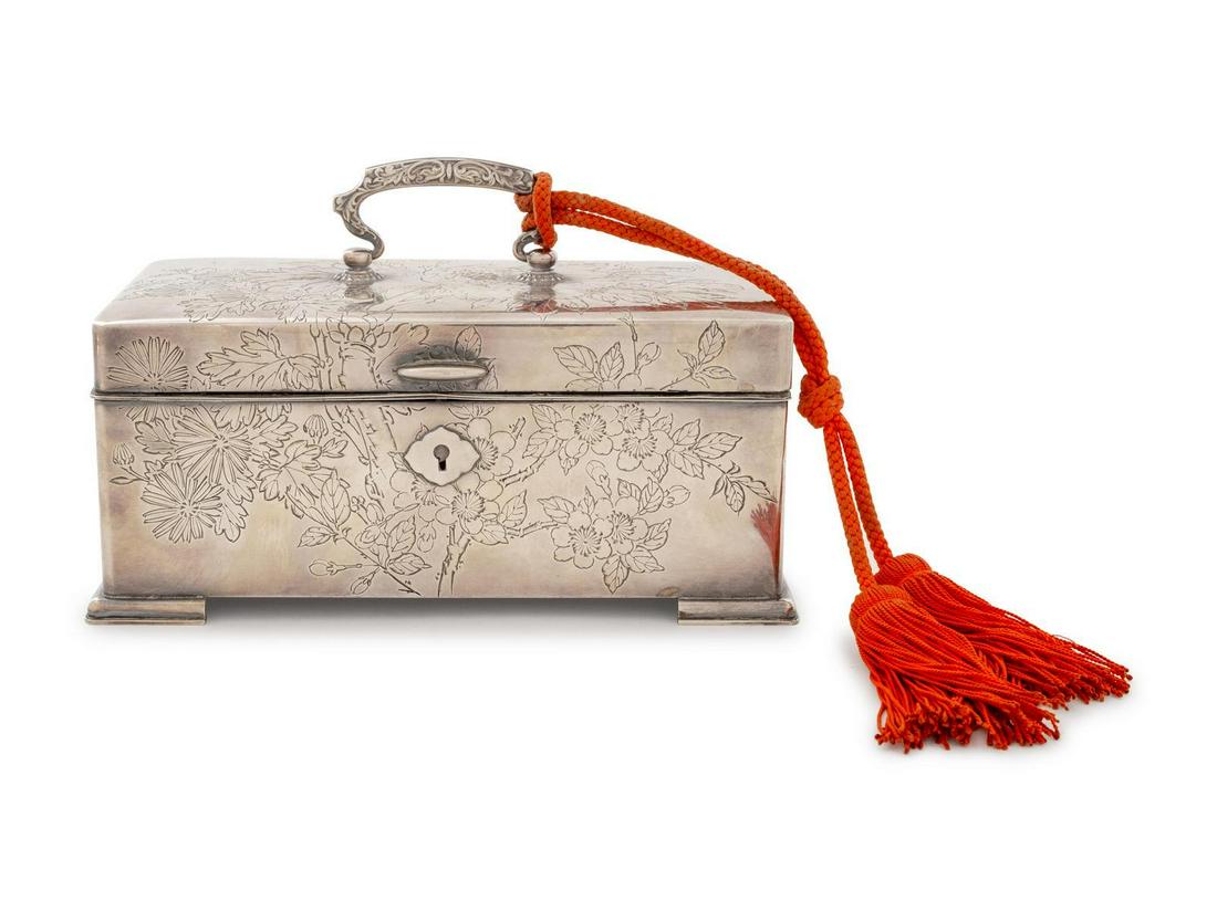 A Japanese Silver Jewelry Casket: A Japanese Silver Jewelry Casket Illegible Three-Character Mark, Early 20th Century decorated with chrysanthemum and cherry blossom motifs throughout, the lid opening to a compartmented interior. mark