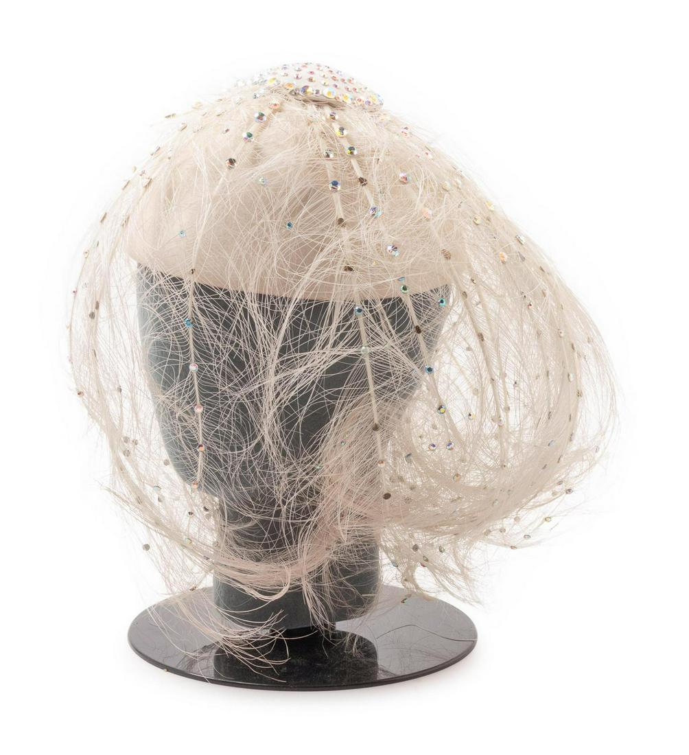 Nine Assorted Hats, 1980-2000s: Nine Assorted Hats, 1980-2000s This lot includes: -One Jean Barthet White Head Wrap with artificial flowers -One b. michael Signature Fascinate with White feathers -Yves Saint Laurent Rive Gauche Purp