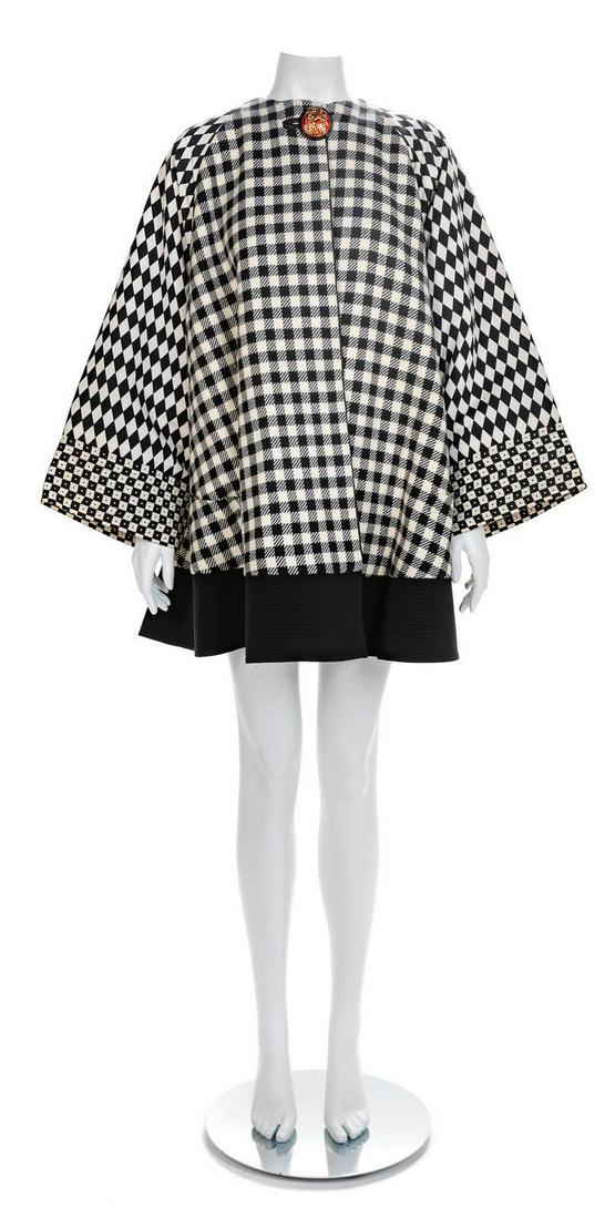 Versace Multicolor, Black and White Swing Coat, 1990s: Versace Multicolor, Black and White Swing Coat, 1990s The main body of the swing coat is padded and made of black and white plaid wool with black and white printed silk sleeves and cuffs. The coat is