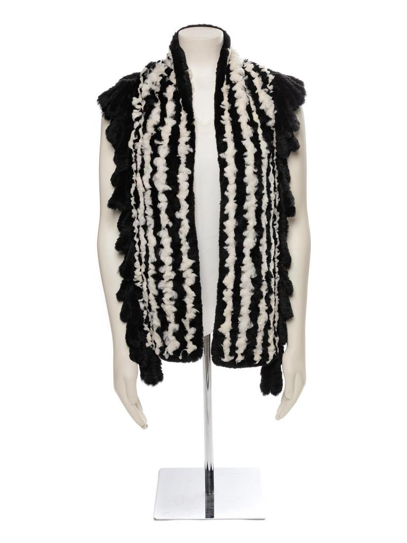 Trilogy Black and White Fur Scarf, 1990-2000s: Trilogy Black and White Fur Scarf, 1990-2000s Black and white rabbit fur knit scarf with fringe. Approximate Flat Measurements Across Front: Width: 10" Length: 64"