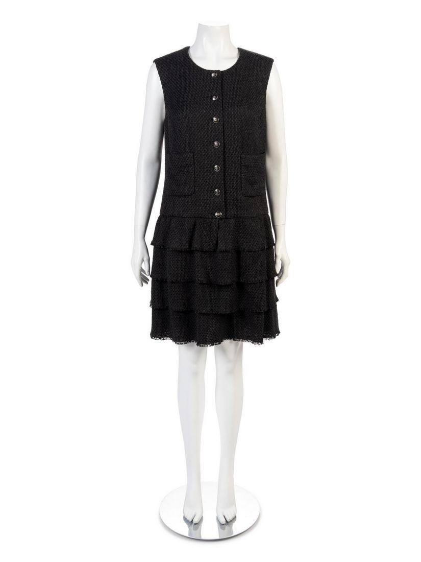 Chanel Dress, 2000s: Chanel Dress, 2000s Strapless black cotton blend boucle dress with a four-tier peplum skirt and center front CC button closure. Label: Chanel / Made in France Size Label: 42 Approximate Flat Measureme