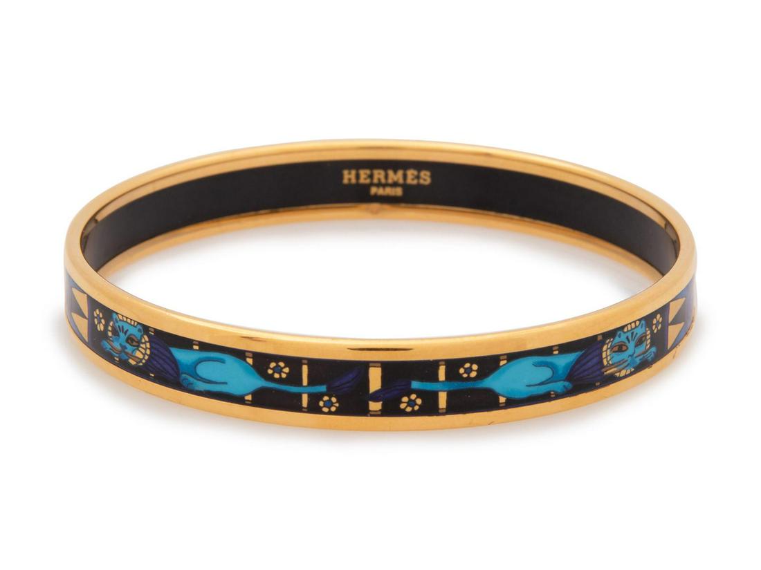 An Hermes Narrow Enameled Bracelet, 2000s: An Hermes Narrow Enameled Bracelet, 2000s with cat motif in blue, indigo, black, and gold. Stamped: Hermes Paris Made in Austria Property of an Important Midwestern Collector