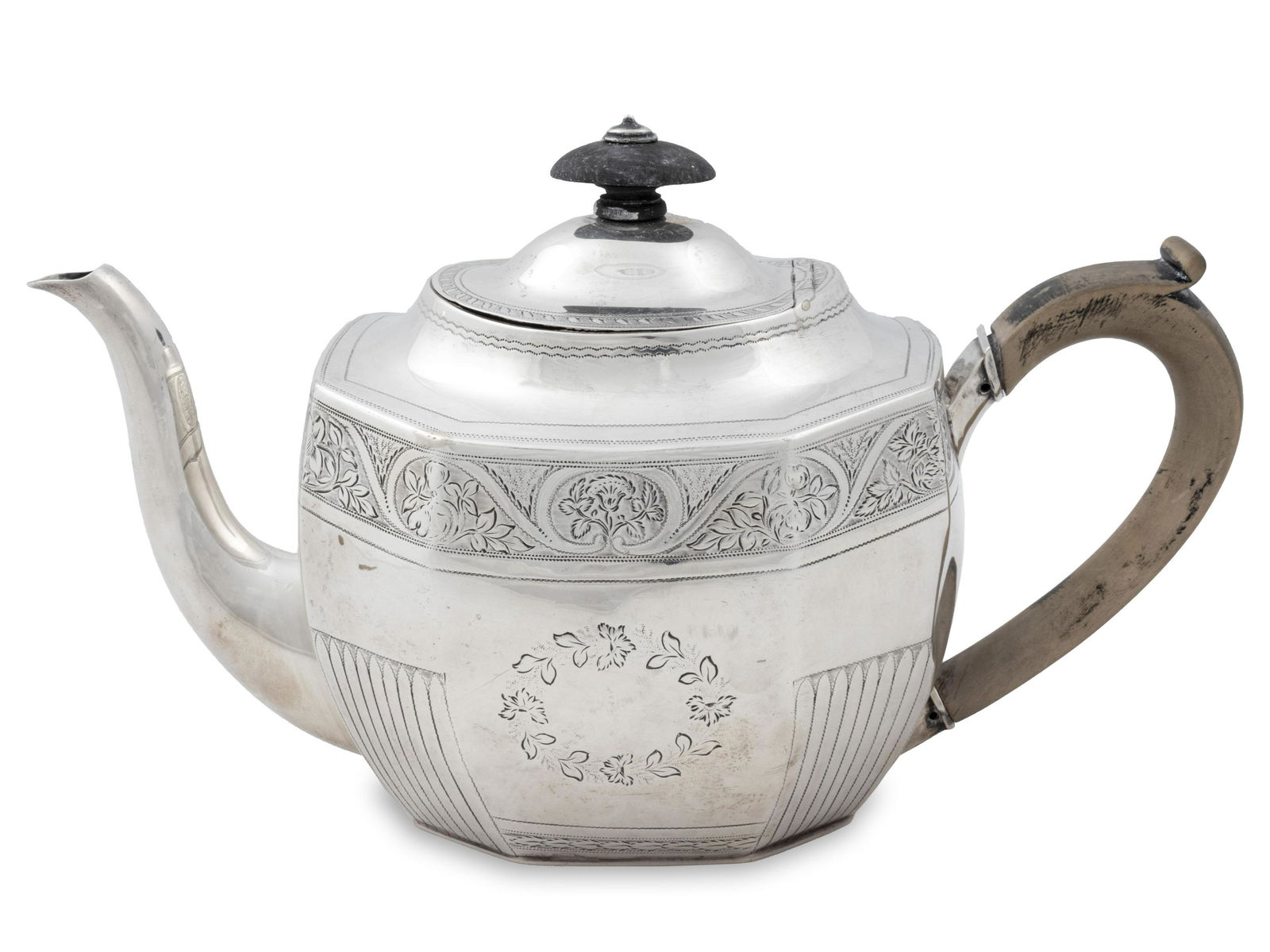 A George III Silver Teapot Height 6 1/2 x length over: A George III Silver Teapot Thomas Whipam, London, 1805 The octagonal body decorated with scrolling floral and leaftip bands, scrolled spout and wood handle, ebony knop. 14 ozt 36 dwts. gross. Height 6