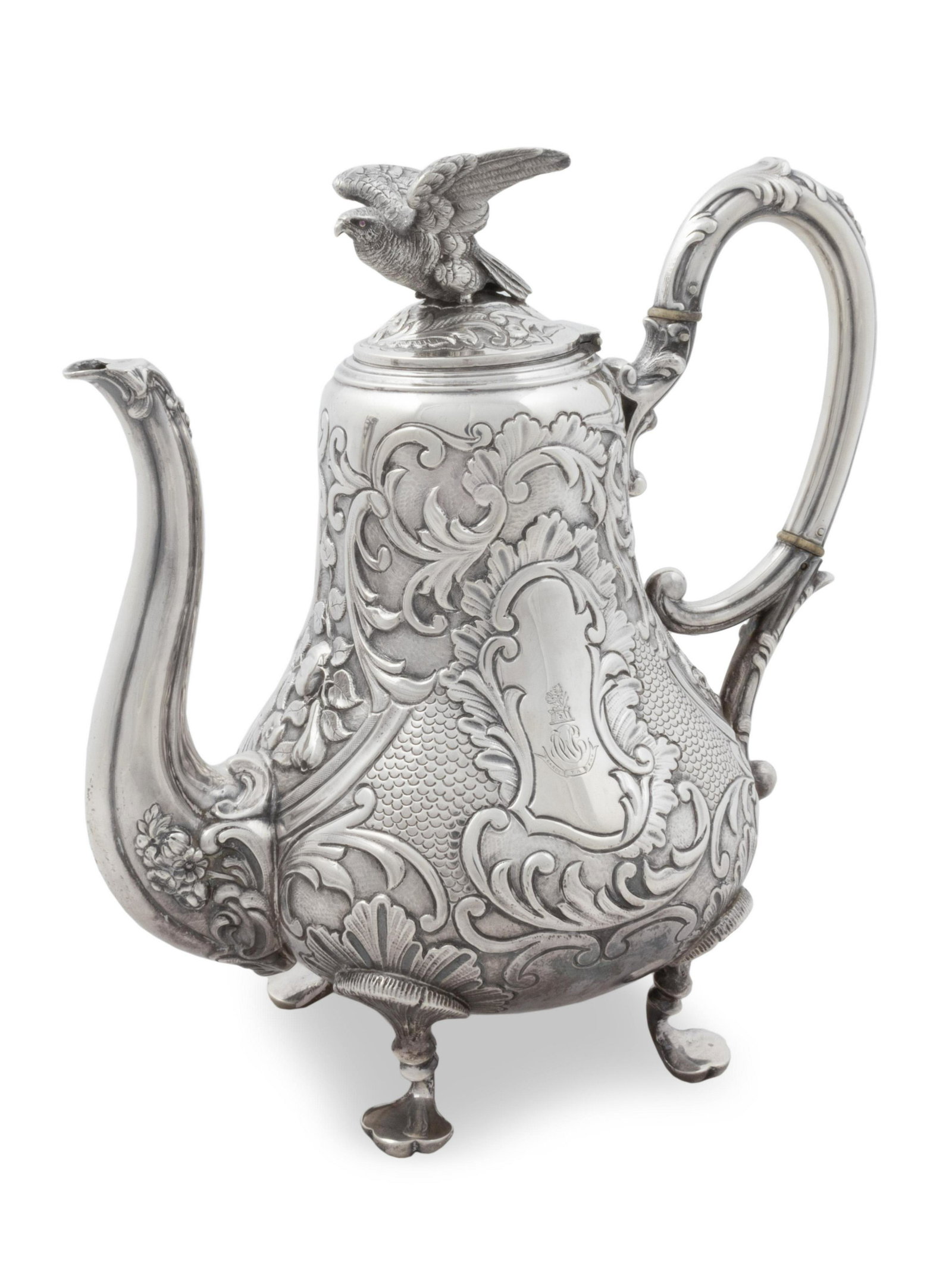 A Louis Philippe Silver Teapot Height 9 x length over: A Louis Philippe Silver Teapot Jean Francois Veyrat, Paris, 1831-1840 The pear-shaped body decorated with ruffled foliate scrolls against a scaled ground, either side with an engraved armorial, with s