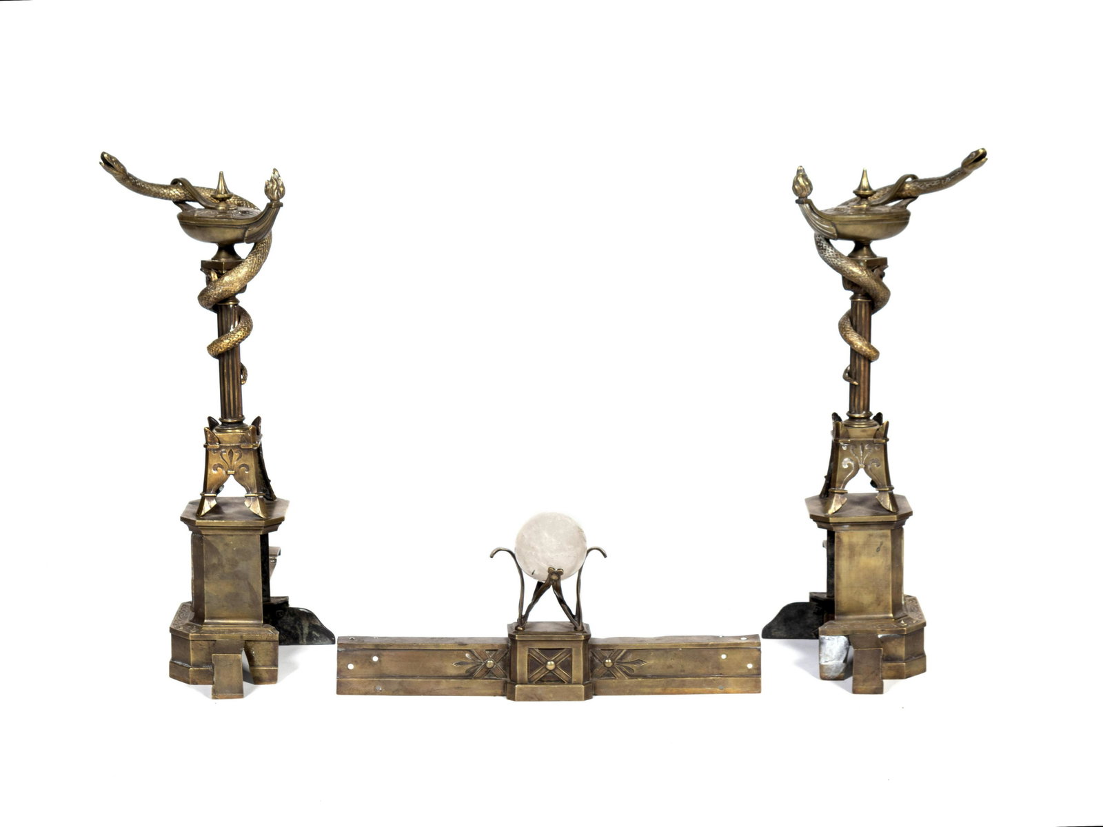 Pair of Neo-Grec Parcel-Gilt and Patinated Bronze: Pair of Neo-Grec Parcel-Gilt and Patinated Bronze Andirons and Fender LATE 19TH CENTURY Each standard conceived as a snake-entwined oil lamp on a columnar stand, on splayed feet over a pedestal base, 