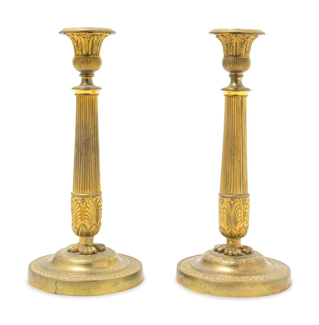A Pair of Empire Style Gilt Bronze Candlesticks: A Pair of Empire Style Gilt Bronze Candlesticks Late 19th/Early 20th Century Height 10 3/4 inches. Property from the Collection of Dr. Gregory Boshart and Dr. William Lawrence, Chicago, Illinois