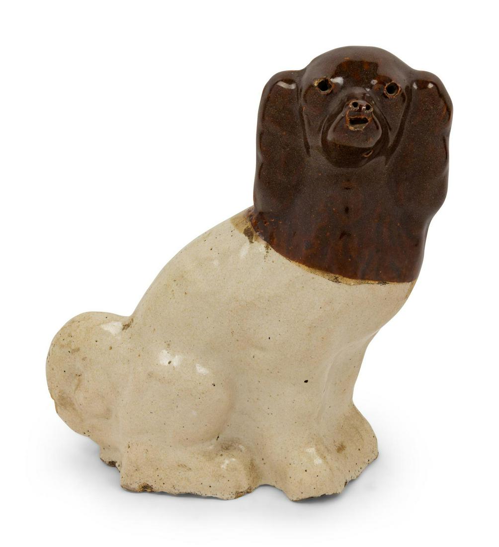 A Brown-Glazed Stoneware Dog Figure: A Brown-Glazed Stoneware Dog Figure Height 10 1/4 inches Property from the Collection of Michael and Janice Doniger, Chicago, Illinois