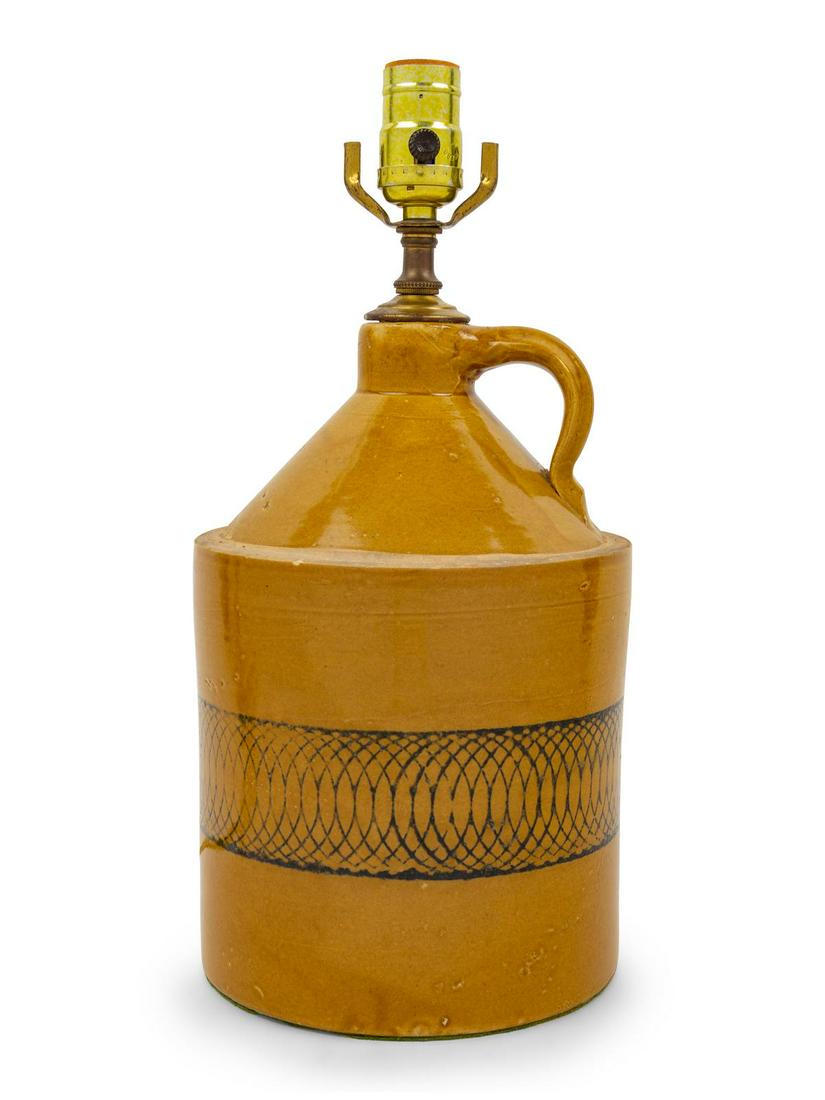 A Glazed and Transfer-Decorated Stoneware Jug: A Glazed and Transfer-Decorated Stoneware Jug Late 19th Century mounted as a lamp. Height of jug 10 3/4 inches. Property from the Collection of Michael and Janice Doniger, Chicago, Illinois