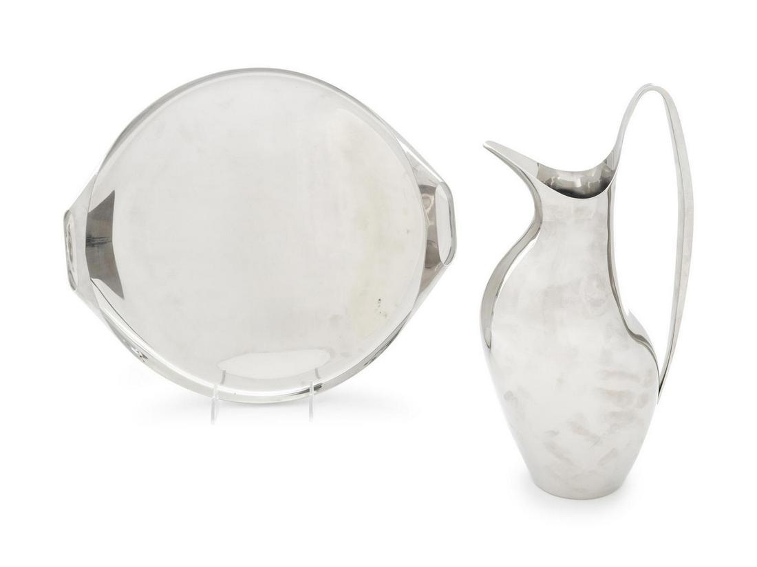 A Danish Stainless Steel Water Pitcher and Tray: A Danish Stainless Steel Water Pitcher and Tray Henning Koppel for Georg Jensen Height of pitcher 15 1/2 inches. Property from an Important Chicago Collection