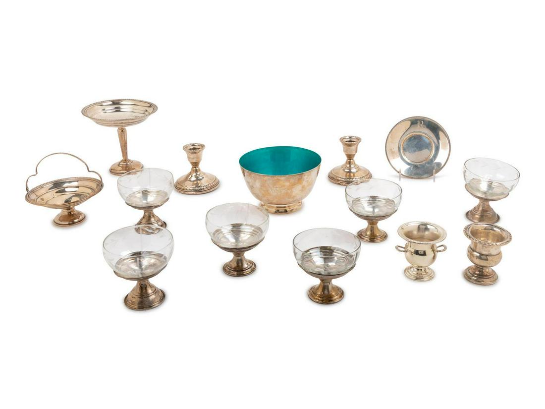 A Group of Fourteen Silver and Silvered Metal Table: A Group of Fourteen Silver and Silvered Metal Table Articles comprising 6 glass and silver sherberts, 2 candlesticks, 2 salts, a tazze, a basket, a dish and an enameled bowl. Height of sherbert 3 1/2