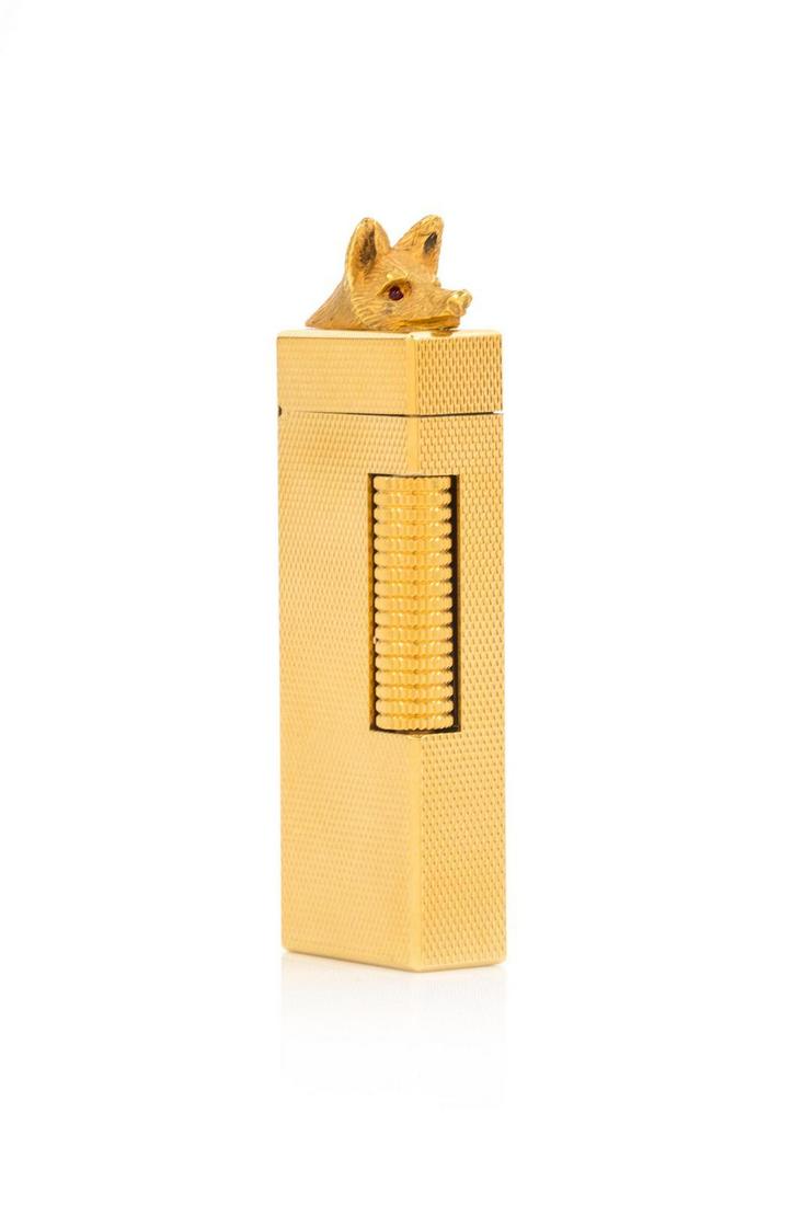 A Dunhill Gilt Metal Lighter: A Dunhill Gilt Metal Lighter 20th Century the lid with an applied fox head having jewel-inset eyes. Height 3 inches. Property from a Midwest Collector