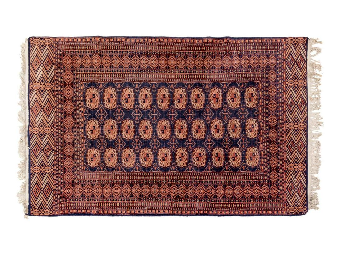 A Bokhara Wool Rug: A Bokhara Wool Rug Mid-20th Century 6 feet 2 inches x 4 feet 1 inch. Property from the Collection of Dr. Gregory Boshart and Dr. William Lawrence, Chicago, Illinois