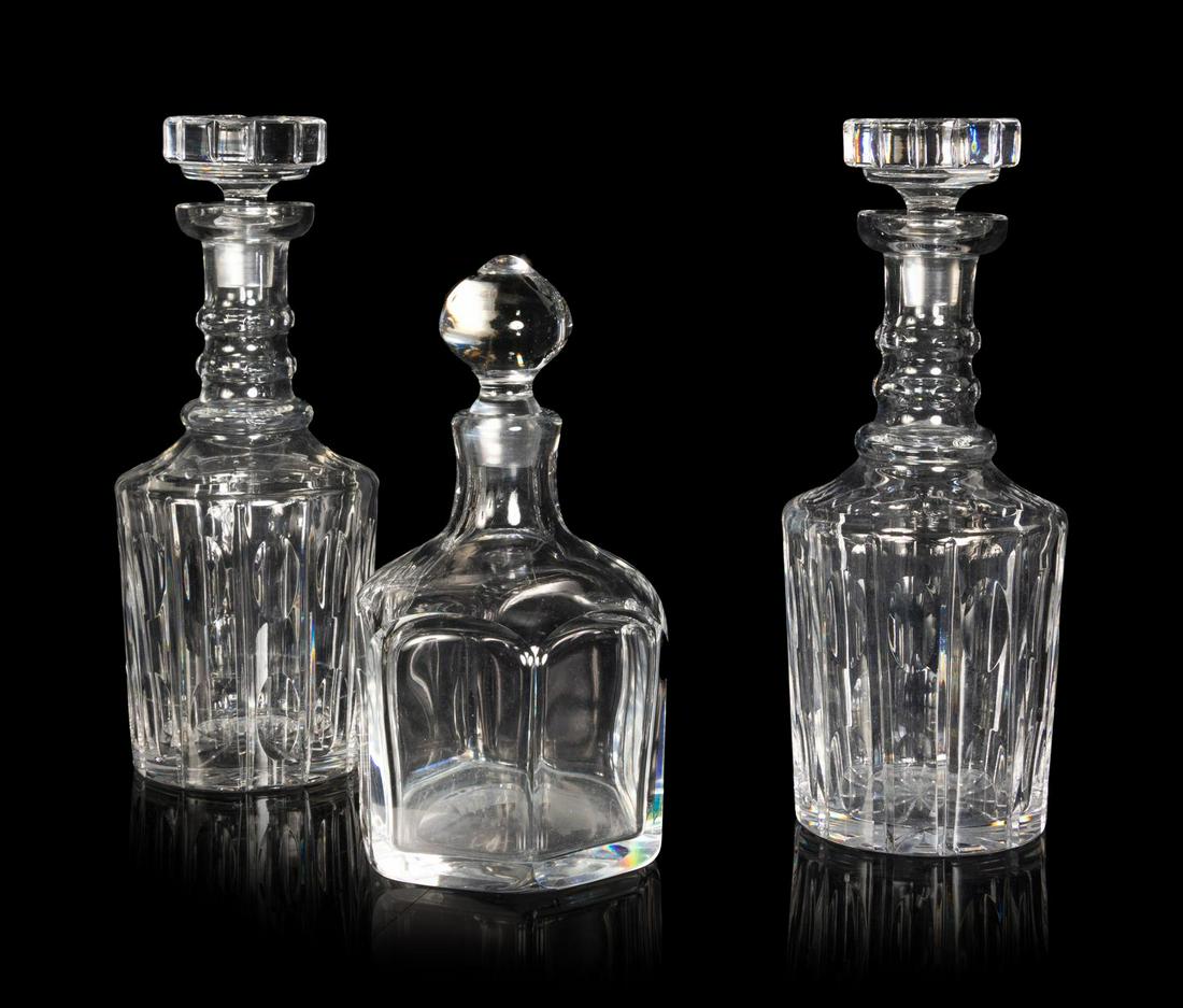 Three Glass Decanters: Three Glass Decanters comprising two cut glass examples and one of hexagonal form. Height of tallest 11 inches. Property from the Collection of Michael and Janice Doniger, Chicago, Illinois