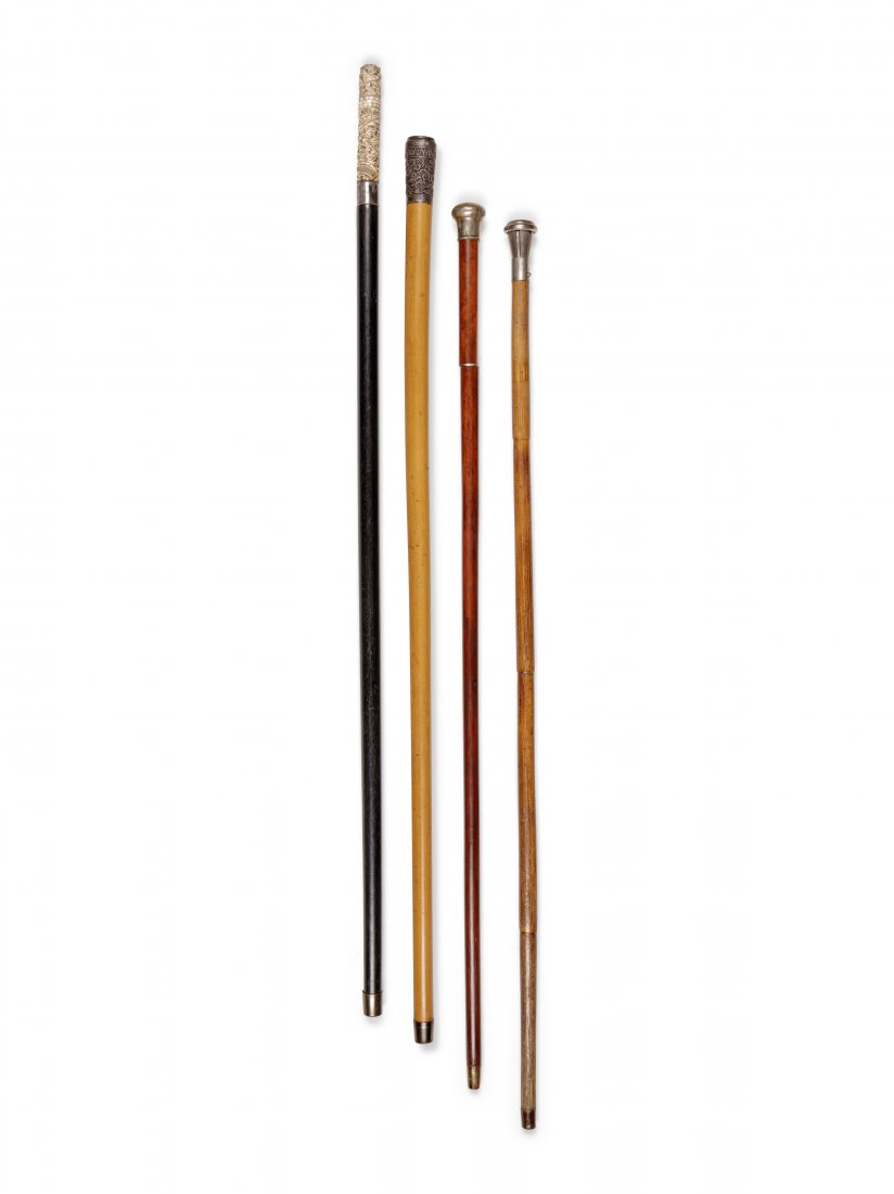 Four Metal-Mounted System Walking Sticks: Four Metal-Mounted System Walking Sticks comprising a steel spring-loaded example; a carved bone example; a compass example and a sword-handled example. Length of longest 37 1/2 inches.