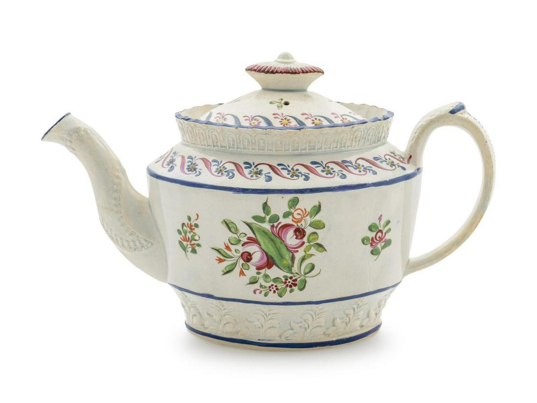 An English Creamware Teapot Height 6 x width 9 1/2: An English Creamware Teapot 19TH CENTURY Height 6 x width 9 1/2 inches.
