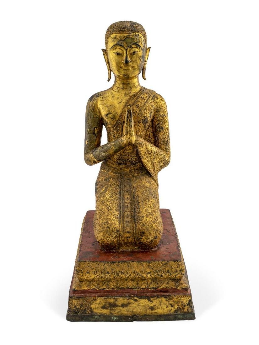 A Burmese Gilt Lacquered Bronze Buddhist Attendant: A Burmese Gilt Lacquered Bronze Buddhist Attendant 19TH CENTURY Height 26 1/2 x width 11 3/4 x depth 16 inches.