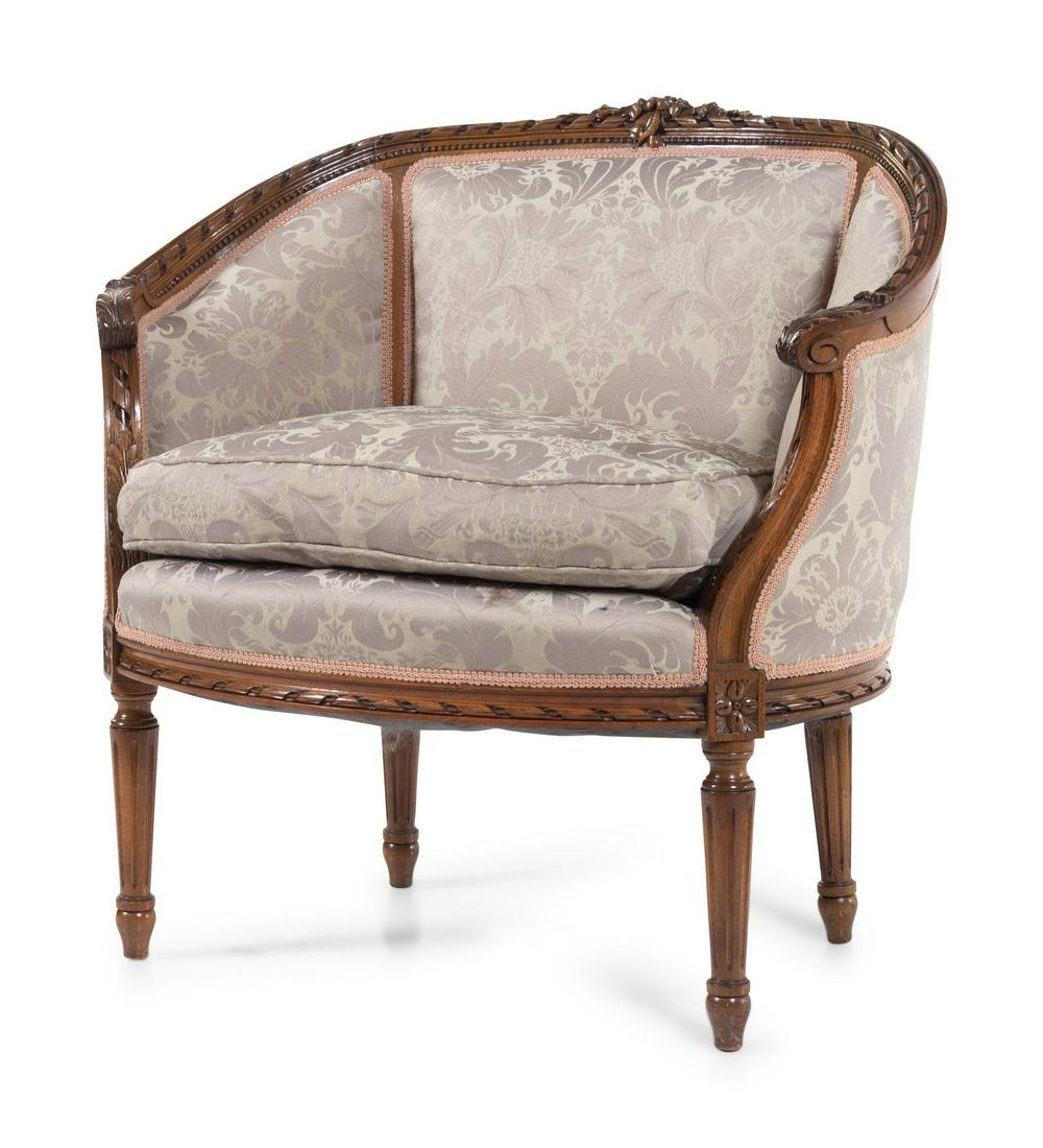 A Louis XVI Style Walnut Bergere: A Louis XVI Style Walnut Bergere 20th Century Height 31 x width 30 x depth 20 inches.