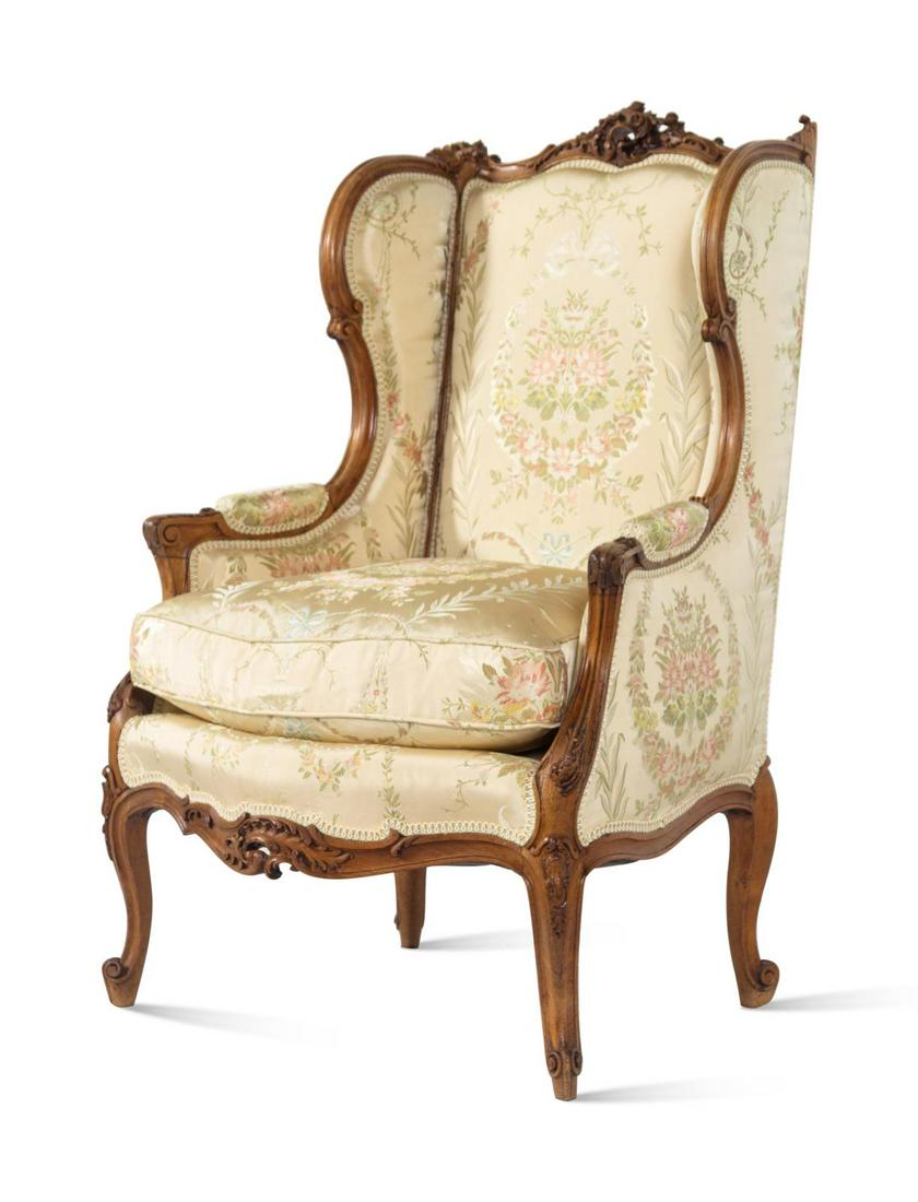 A Louis XV Style Carved Walnut Bergere: A Louis XV Style Carved Walnut Bergere Late 19th Century Height 44 x width 28 1/2 x depth 20 inches.