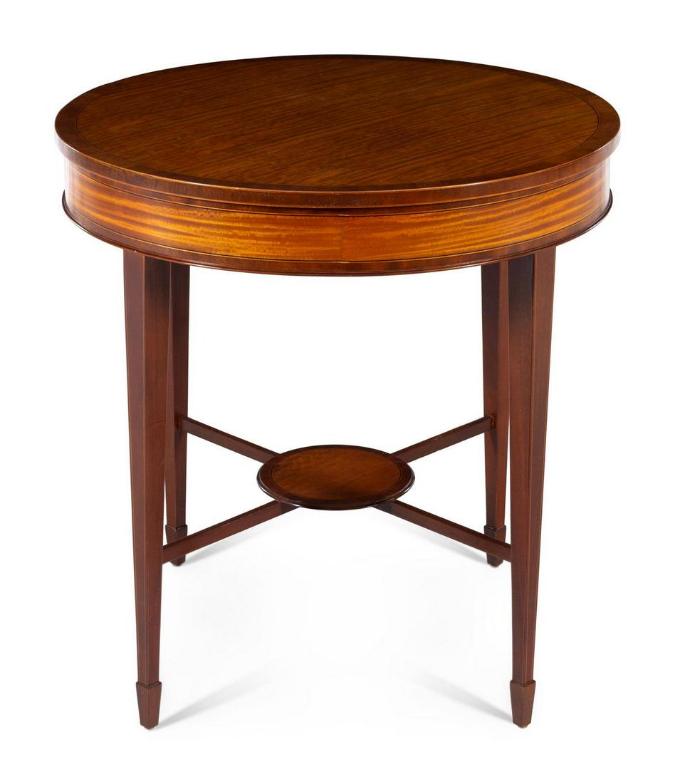 A George III Style Satinwood Occasional Table: A George III Style Satinwood Occasional Table BAKER SECOND HALF 20TH CENTURY having a circular top raised on tapering legs joined by stretchers. Height 28 x diameter 28 inches. Property from the Colle