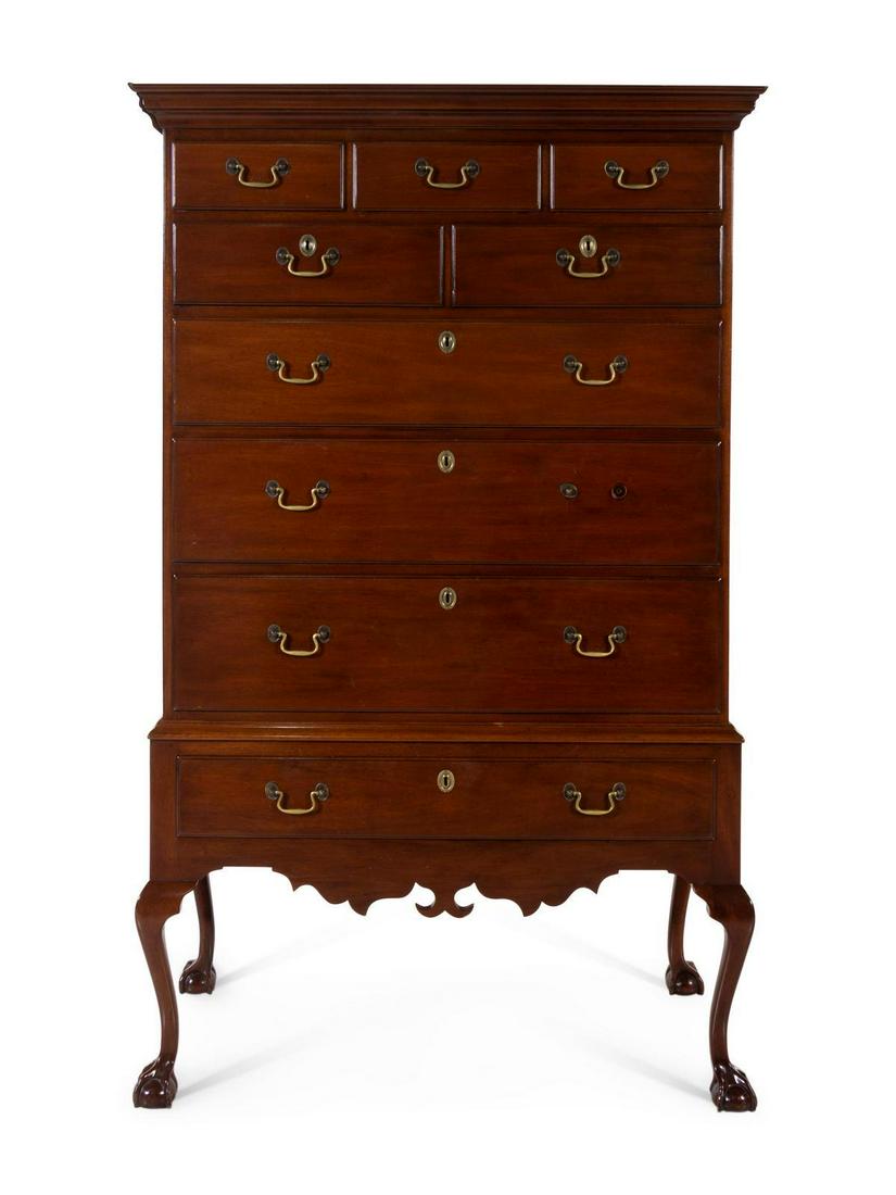 A Chippendale Style Mahogany Tall Chest: A Chippendale Style Mahogany Tall Chest KITTINGER 20TH CENTURY having a molded cornice over nine drawers, raised on cabriole legs ending in claw and ball feet. Height 70 x width 43 x depth 22 inches.