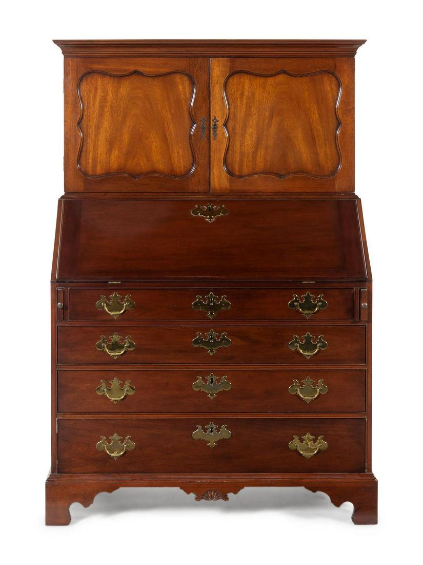 A Chippendale Style Mahogany Secretary Bookcase: A Chippendale Style Mahogany Secretary Bookcase KITTINGER 20TH CENTURY with two doors and a fall front over four drawers. Height 61 x width 41 x depth 21 inches. Property from the Collection of Karl Z