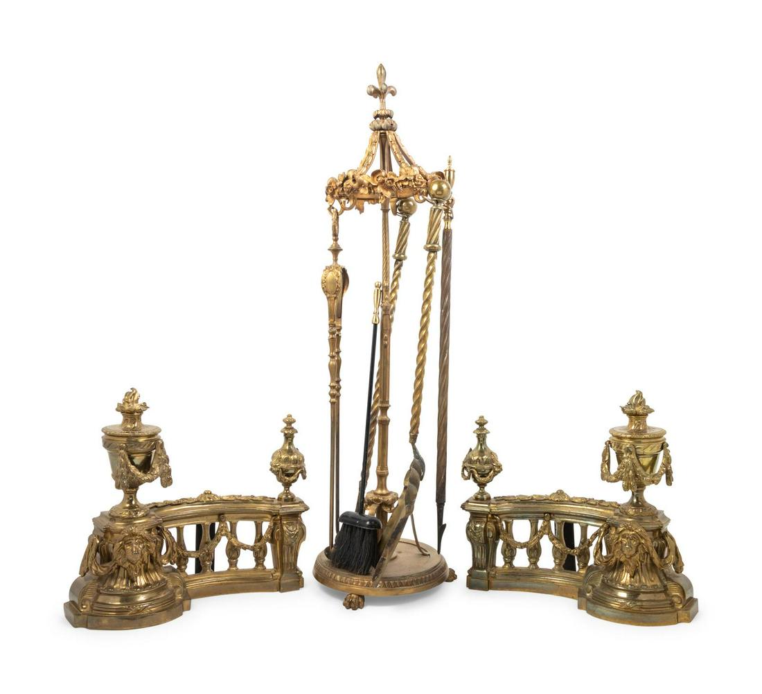 A Set of Regency Style Gilt Bronze Fireplace Tools: A Set of Regency Style Gilt Bronze Fireplace Tools comprising a pair of chenets, together withÂ a pair of tongs, a shovel, a brush and a poker, set in a stand.Â Height of stand of 36 1/2 inches.