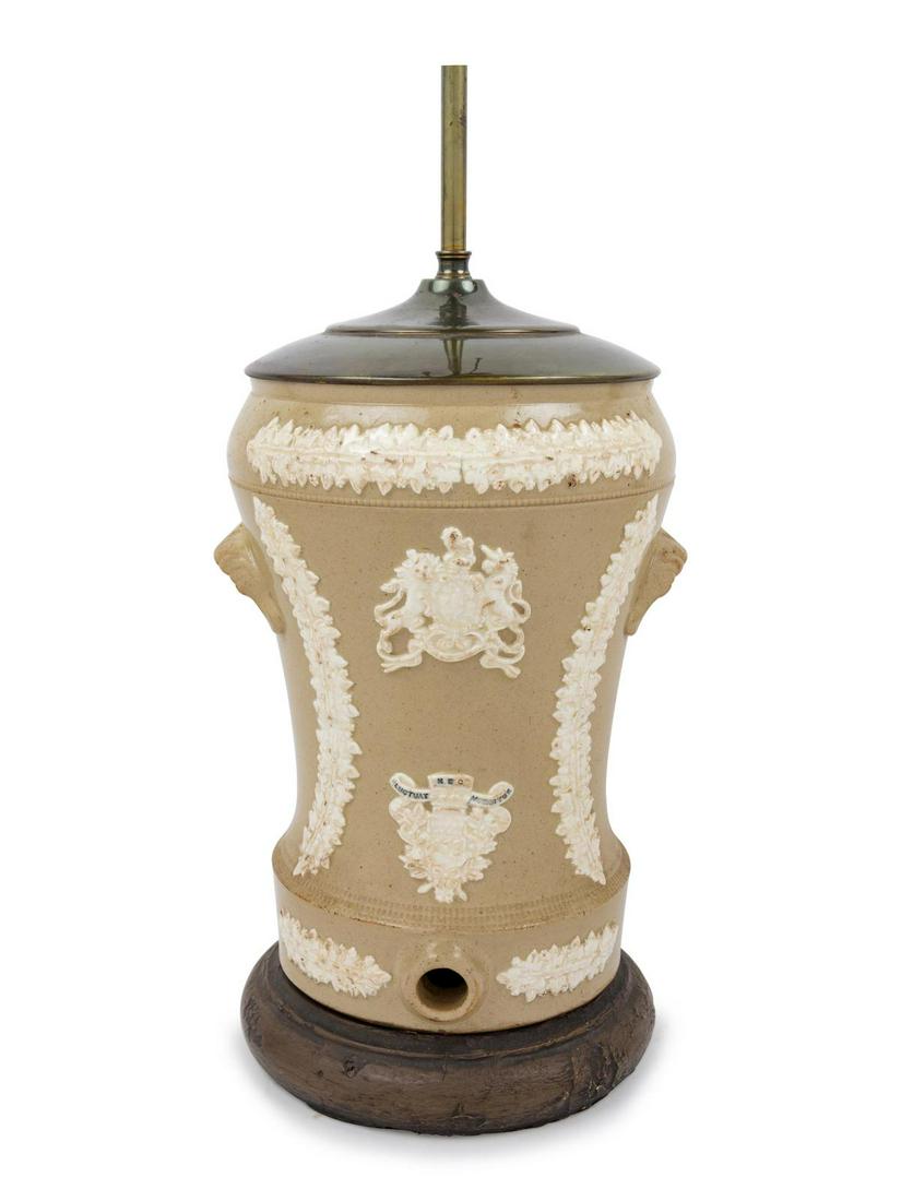An English Salt-Glazed Stoneware Water Cooler: An English Salt-Glazed Stoneware Water Cooler 19th Century mounted as a lamp. Height of cooler 12 1/2 inches. Property from the Collection of Michael and Janice Doniger, Chicago, Illinois