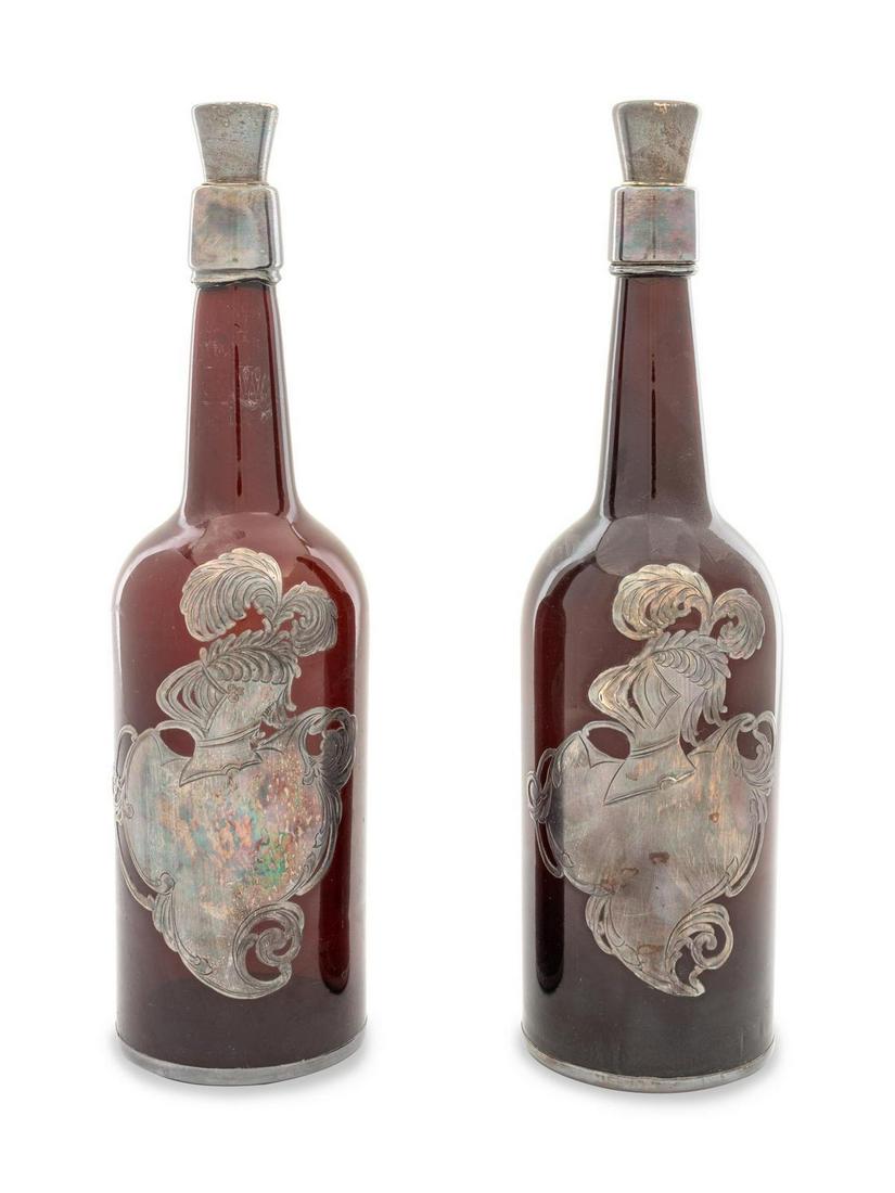 A Pair of Silver Overlay Whiskey Bottles: A Pair of Silver Overlay Whiskey Bottles Early 20th Century with stoppers. Height 12 1/4 inches.