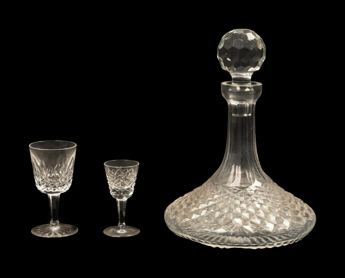 A Waterford Cut Glass Decanter and Glass Service Height: A Waterford Cut Glass Decanter and Glass Service comprising a decanter with a stopper, 6 dessert wine stems, 8 cordials and 4 shot glasses; 19 items total. Height of decanter 10 inches.