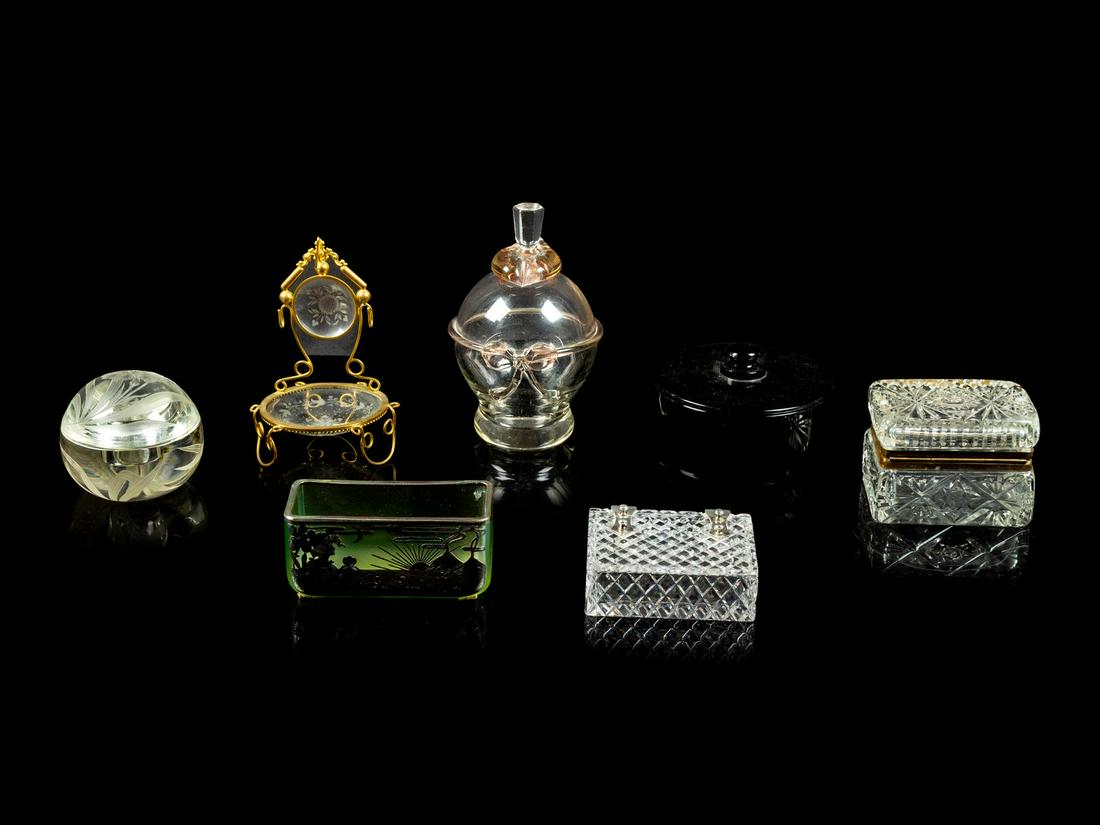 A Collection of Glass Table Articles: A Collection of Glass Table Articles Primarily 20th Century comprising a stoppered bottle, a wheel cut paperweight, a silver overlay bowl, a gilt metal mounted throne and three boxes. Width of widest 